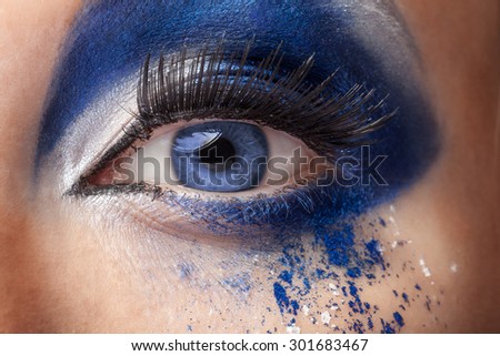 Blue eye with fantasy fashion make up. Close up studio shooting. Beauty and high end fashion make up