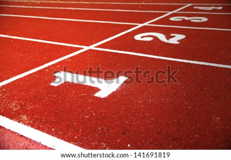 Lanes one,two,three and four marked on a red rubber track