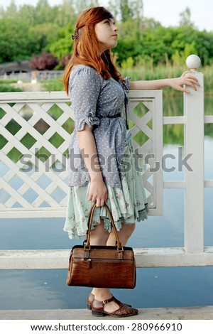 girl at a pond, girl with a vintage bag