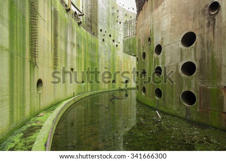 Curved concrete walls outside the core of an abandoned nuclear power plant