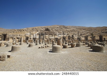 Persepolis, Iran. October 13, 2012. Ruins of columns. In the hill is an ancient tomb. In this place they kept their treasures in antiquity
