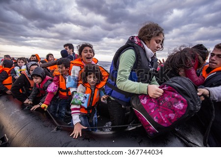 Lesvos island, Greece - 29 October 2015. Syrian migrants / refugees arrive from Turkey on boat through sea with cold water near Molyvos, Lesbos on an overload dinghy. Leaving Syria that has war.