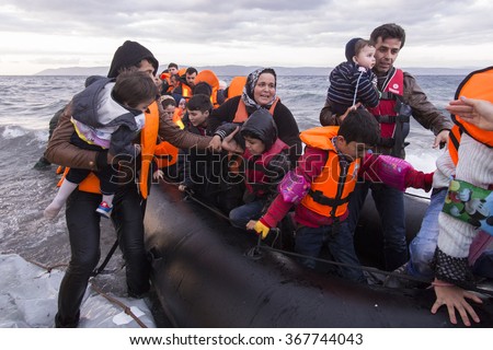 Lesvos island, Greece - 29 October 2015. Syrian migrants / refugees arrive from Turkey on boat through sea with cold water near Molyvos, Lesbos on an overload dinghy. Leaving Syria that has war.