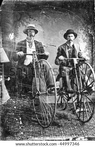 stock photo Vintage black and white tintype of two men on high wheel Penny 
