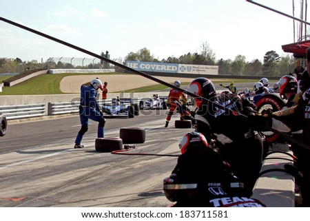 Birmingham Alabama USA - April 10, 2011: Pit stop action as teams change tires and refuel the race cars.