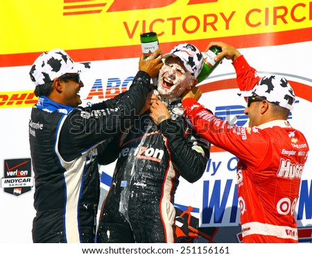 Milwaukee Wisconsin, USA - August 17, 2014: Verizon Indycar Series Indyfest. 1st place race winner, Will Power,  gets champagne bath from Tony Kanaan and Juan Pablo Montoya