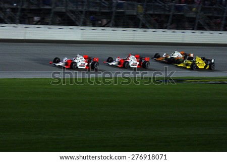 Joliet Illinois, USA - August 29, 2009: IndyCar Racing League. Nighttime Race action on track, cars running wheel to wheel, Chicagoland speedway.  Peak Antifreeze & Motor Oil Indy 300
