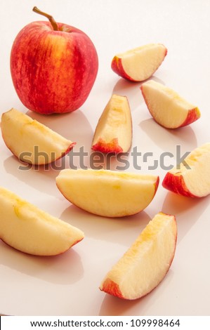 Apple and apple slices on white background.
