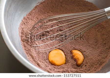 Chocolate cake flour preparation with whisk and eggs
