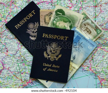 Two U.S. passports on map with foreign currency