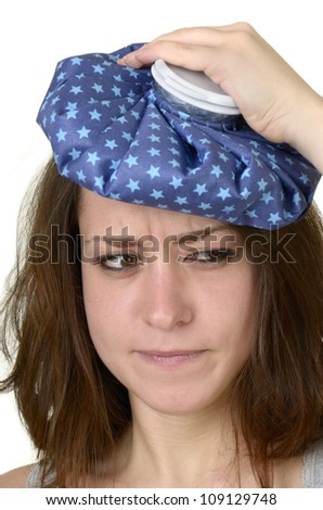 young woman with ice pad before white background, isolated, studio shot
