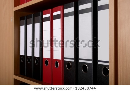 Different Files in office cupboard, close up