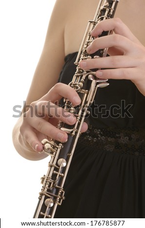 Woman in evening dress playing oboe, detail, Studio Shot