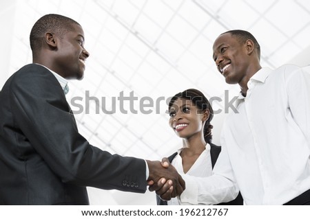 Three african business people handshake, Studio Shot, Cameroon