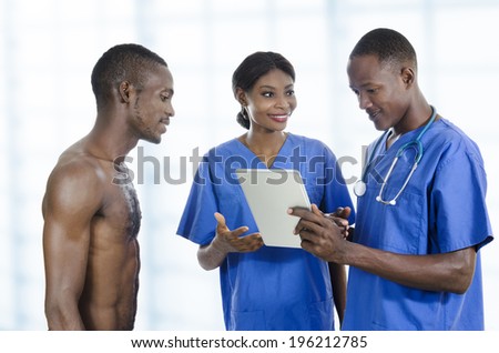 African health care team with tablet PC and patient, Studio Shot