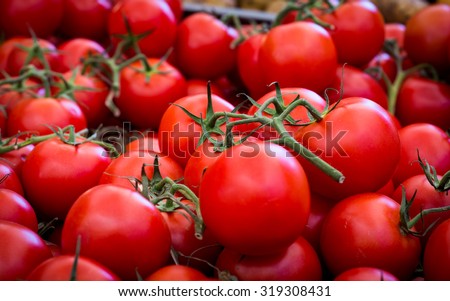 Red ripe tomatoes in a market/basket/carton for sale. Farmer's market.