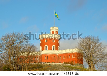 Front view of Kastellholmen\'s castle in Stockholm, Sweden with the swedish flag