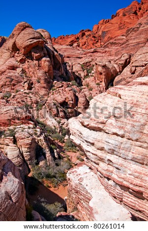 View of dry landscape and red rock formations of the Red Rock Canyon in the Mojave Desert.