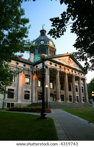 County Seat Court House in city of Binghamton, New York. Sunset illuminates pillars.
