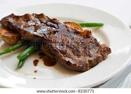 A steak main course meal at a fancy restaurant.