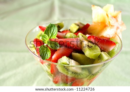 A dessert cup of strawberries, kiwi, and star fruit.
