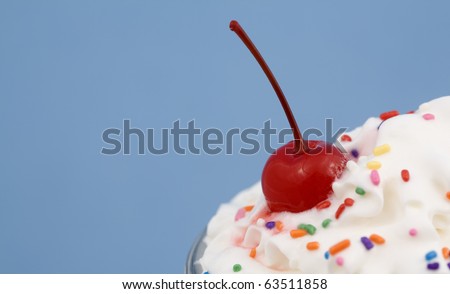 Close-up of an Ice Cream Sundae with rainbow sprinkles, and a cherry on top!