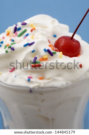 Close-up of an Ice Cream Sundae with rainbow sprinkles, and a cherry on top!