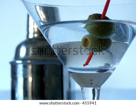 Close up of vodka martini with shaker in background.