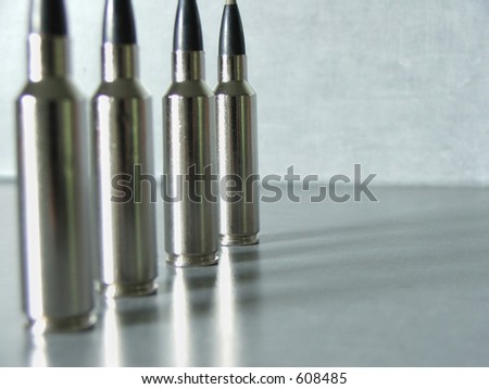 Silver bullets in a row. Focus is on last bullet in the row.