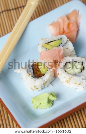 Sushi plate over a bamboo mat. Vertical format.