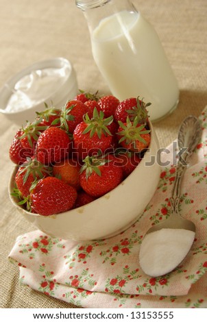 A bounty of fresh garden berries with cream, sugar and whipped cream.