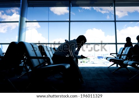 Silhouettes of business people wait and transfer at airport