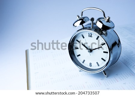 Metal Alarm clock work time on white background 10 am.