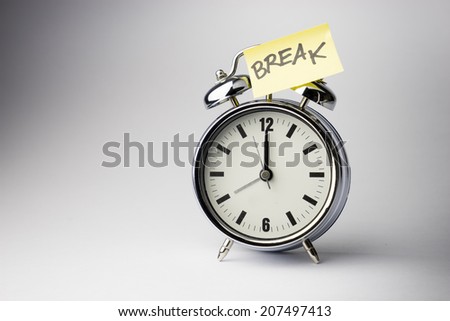 Alarm clock with sticky paper note BREAK time on white background
