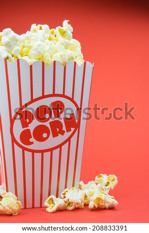 Classic retro box popcorn on red background