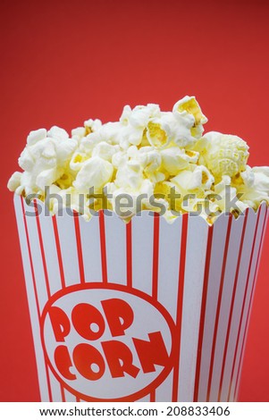 Classic retro box popcorn on red background