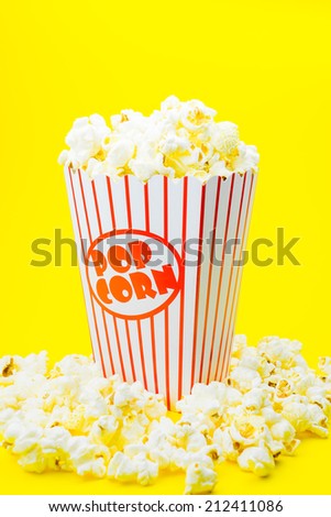 Classic box cinema popcorn on yellow background