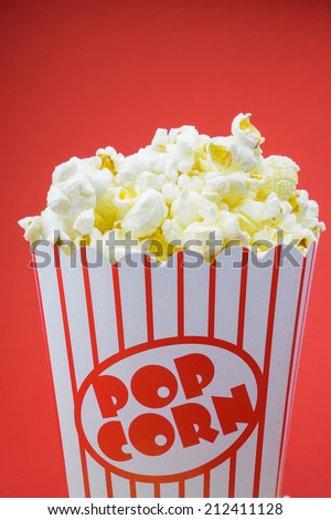 Classic box cinema popcorn on red background