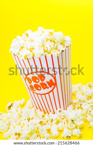 Classic box cinema popcorn on yellow background
