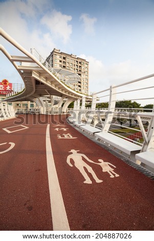 KAOHSIUNG - TAIWAN July 09: Star-of-Cianjhen Bike Bridge is located near Kaisyuan MRT station. People and bicycle can use this bridge across the Kaizuan 4th road. Kaohsiung, Taiwan. on July 09, 2014