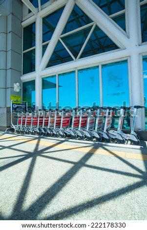 KAOHSIUNG, TAIWAN - JULY 12: Row of luggage carts in front of Kaohsiung Internation airport, July 12, 2014. Kaohsiung International air port is located at south of Taiwan.