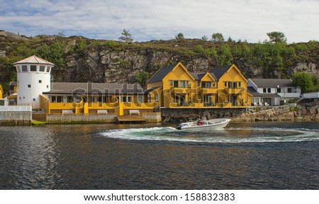 Motorboat on the background of the tourist base in Norway