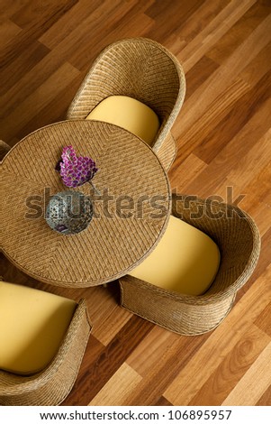 Rattan furniture on wood floor.