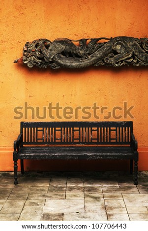 Wooden old chair with thai craft background .