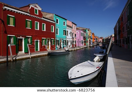 Canal on the island of Burano, near Venice, Italy. The multi-colored houses set the village on this island apart from the city of Venice.