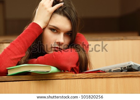 student teen girl beautiful tired in empty classroom university