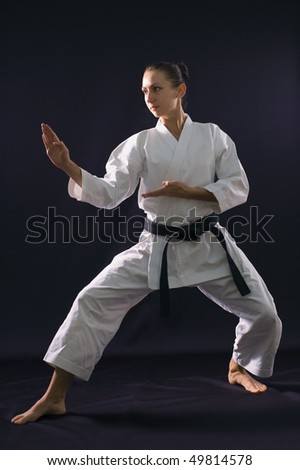 karate girl on black background studio shot