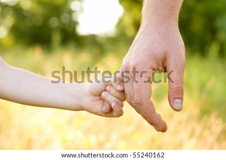 trust family hands of child son and father on wheat field nature outdoor