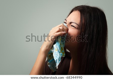 woman flu with cold in head blows nose