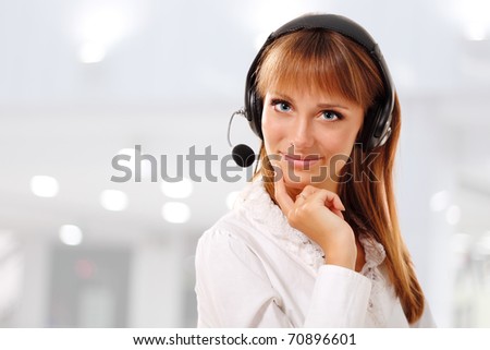 Support phone operator beautiful young woman in headset at workplace
